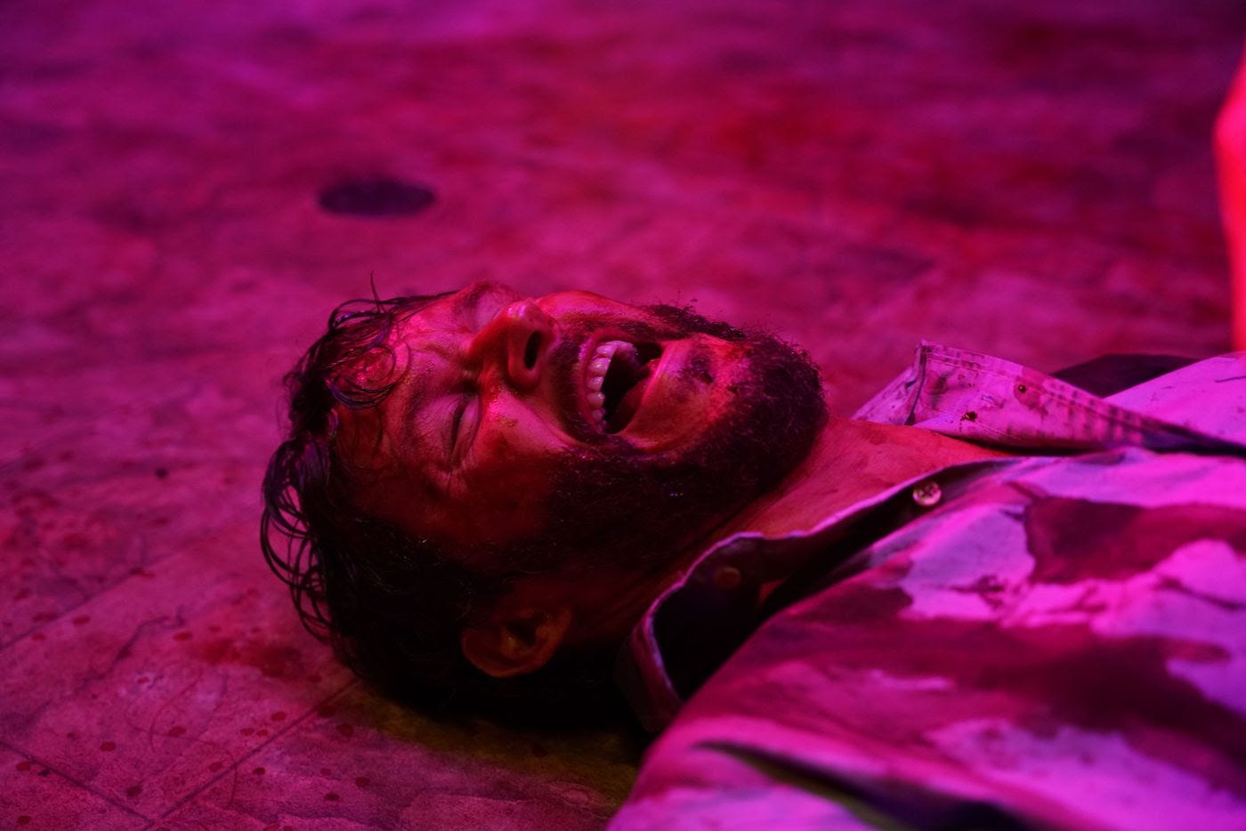 bearded guy in reddish light lying on floor screaming bearded guy in reddish light lying on floor screaming