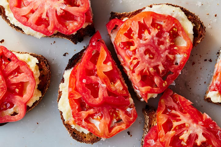 pieces of toast with mayo on top and tomatoes