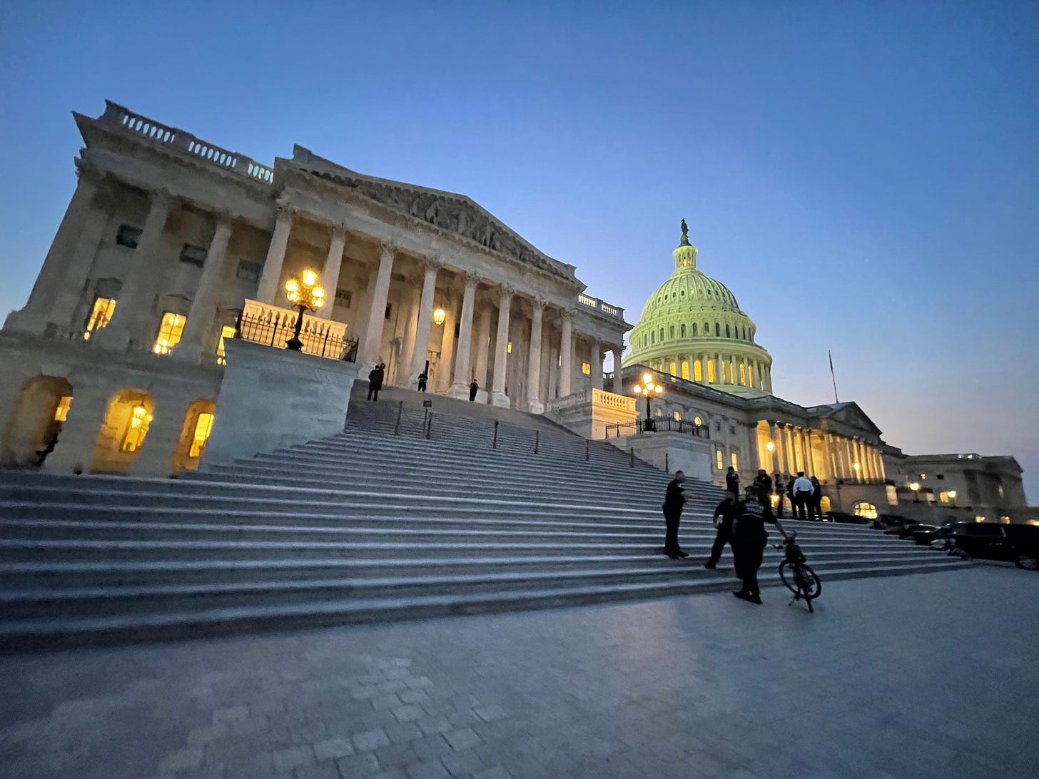 Capitol Police officers chat at the base of the Capitol's steps as sun sets on US Capitol Capitol Police officers chat at the base of the Capitol's steps as sun sets on US Capitol