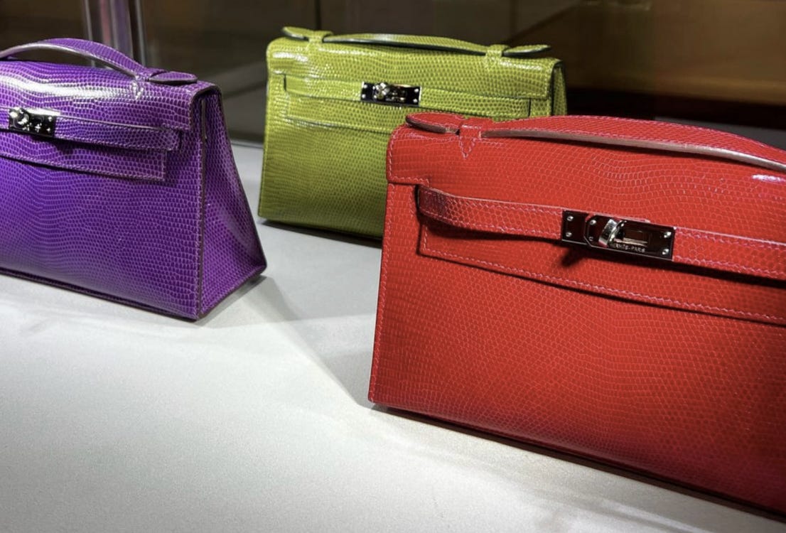A Trio of Hermes Lizard Kelly Pochettes in a recent Sotheby’s Auction