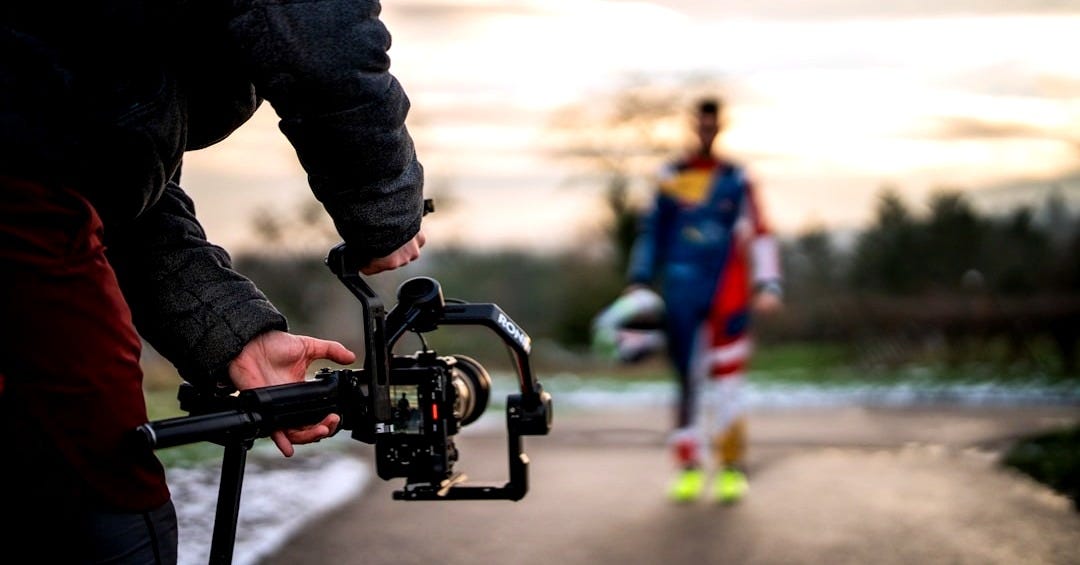 Filming a person with a camera gimbal outdoors. Filming a person with a camera gimbal outdoors.