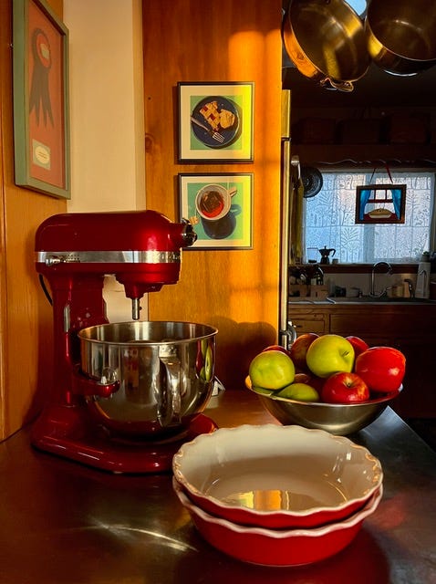 Red food mixer and dishes of fruit on a counter top. Red food mixer and dishes of fruit on a counter top.