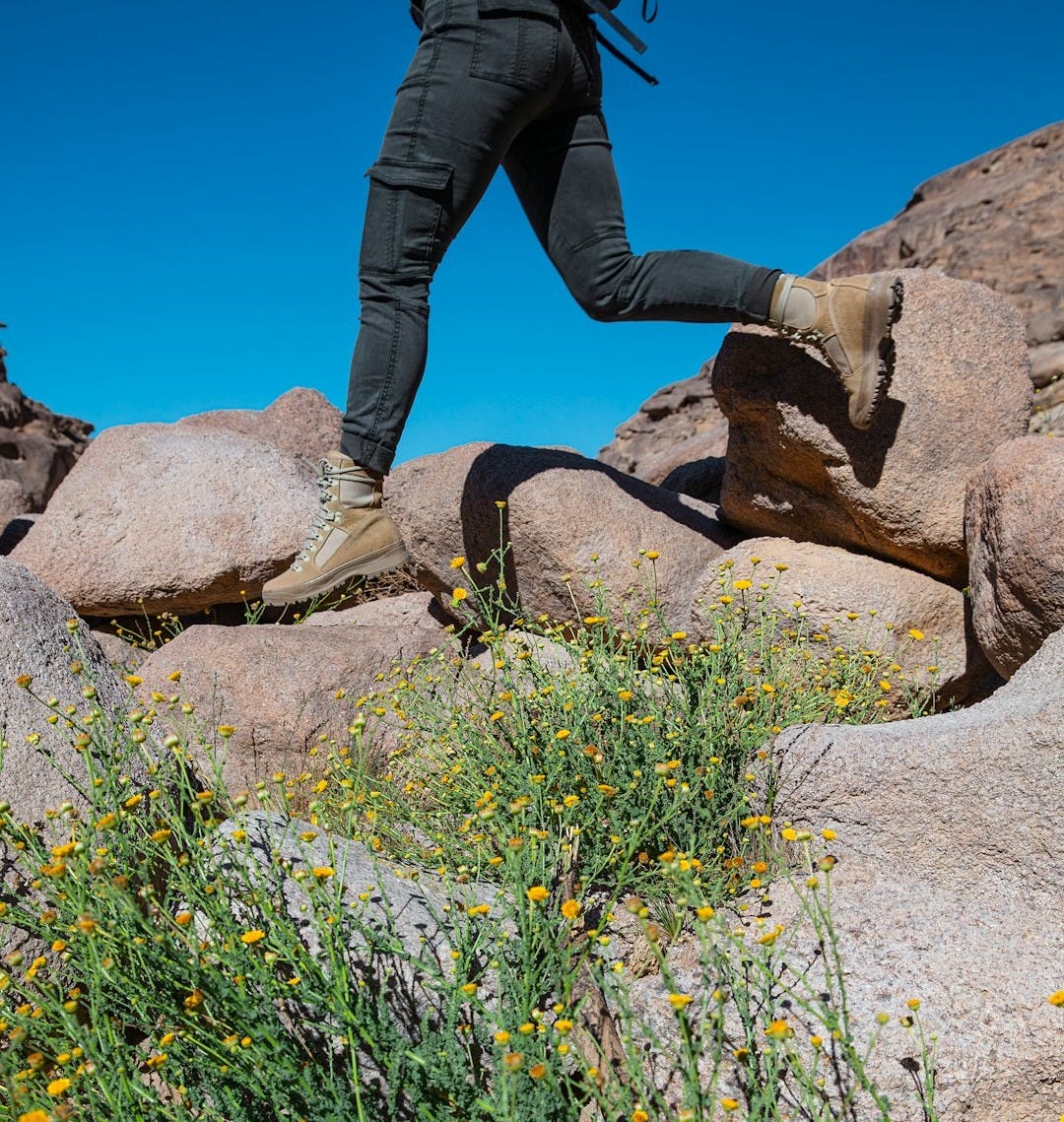a man with a backpack is running on rocks