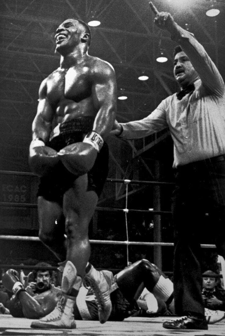 This may contain: two men standing next to each other in a boxing ring