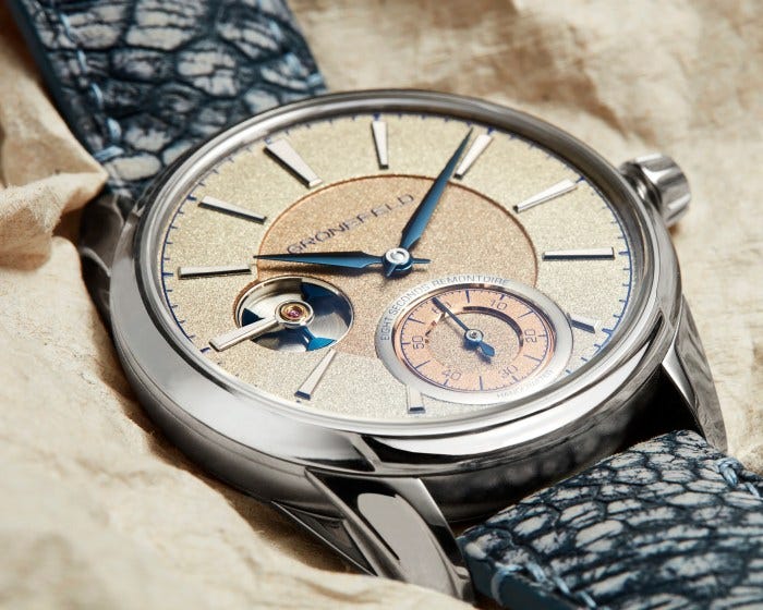 The remontoire mechanism is visible through a cutout on the left side of the dial. The remontoire mechanism is visible through a cutout on the left side of the dial.