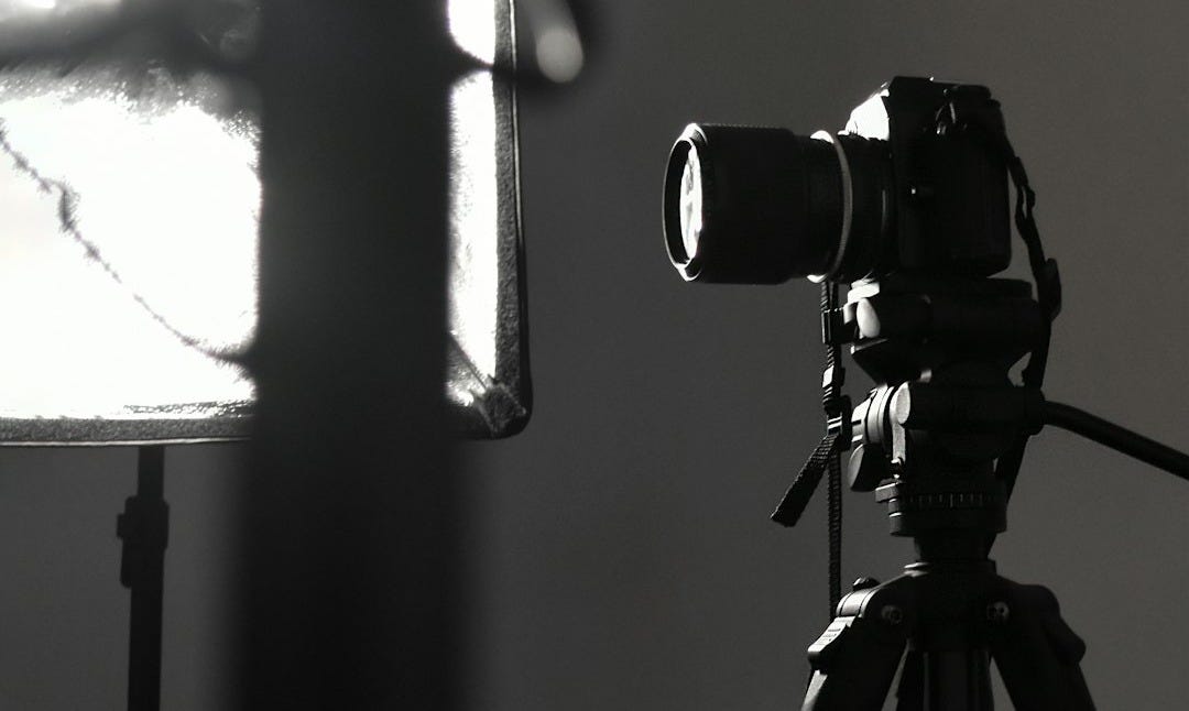 black camera on tripod in grayscale photography black camera on tripod in grayscale photography