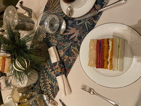 Far left is a white plate with sweet afternoon tea desserts, in the middle is a takeaway baby pink coffee cup with The Langham branding in front of a Christmas tree with lights, far right is a decorative table with afternoon tea sandwiches.
