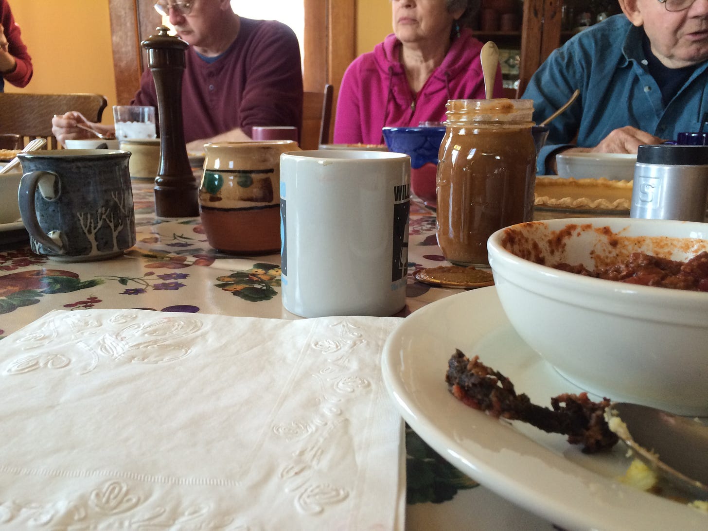 People sitting around a dining table full of food