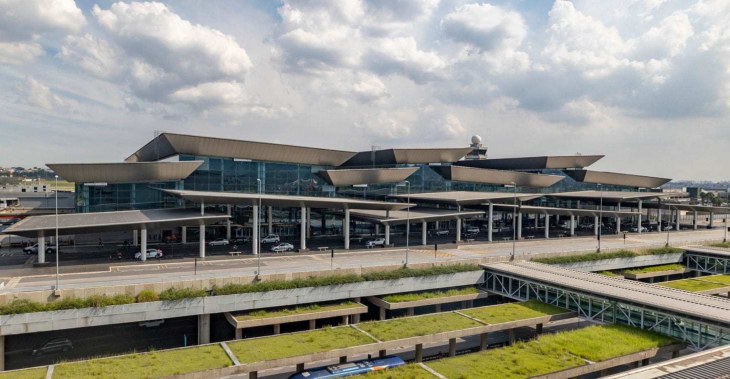 A large airport terminal under a modern roof structure