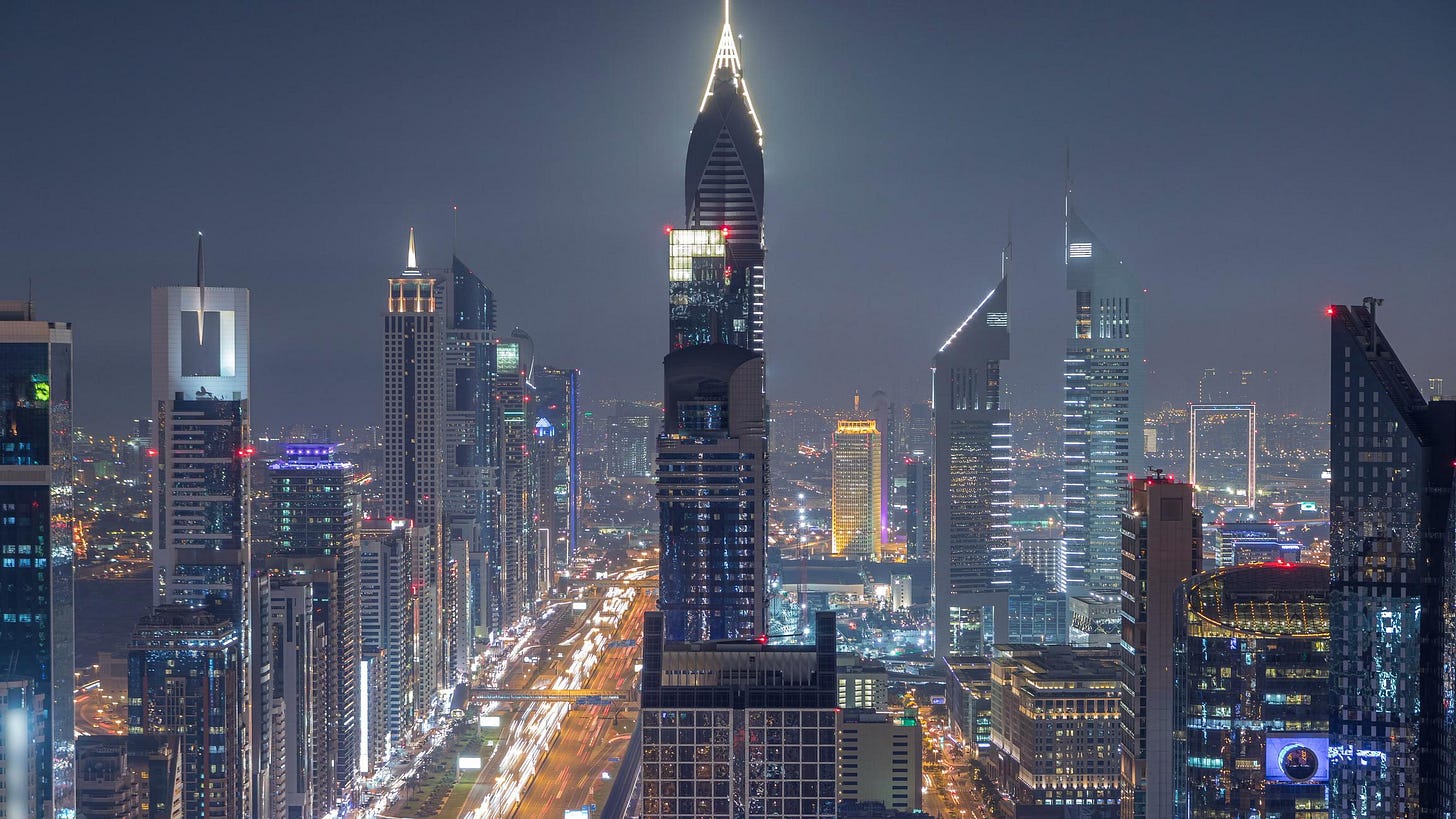 Scenic Dubai downtown skyline at night timelapse. Rooftop view of Sheikh Zayed road with numerous illuminated towers.