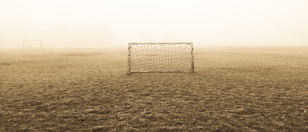 soccer goal on brown field