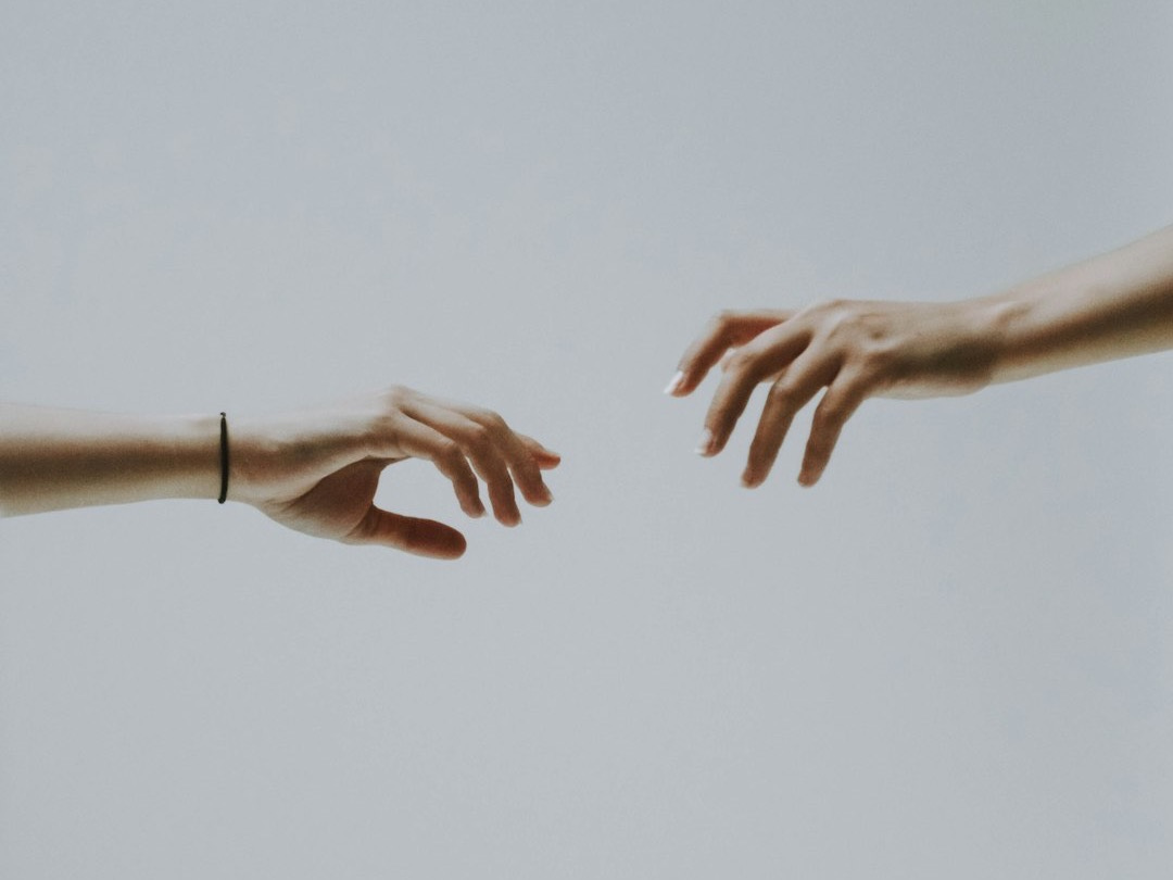 two hands about to hold wallpaper