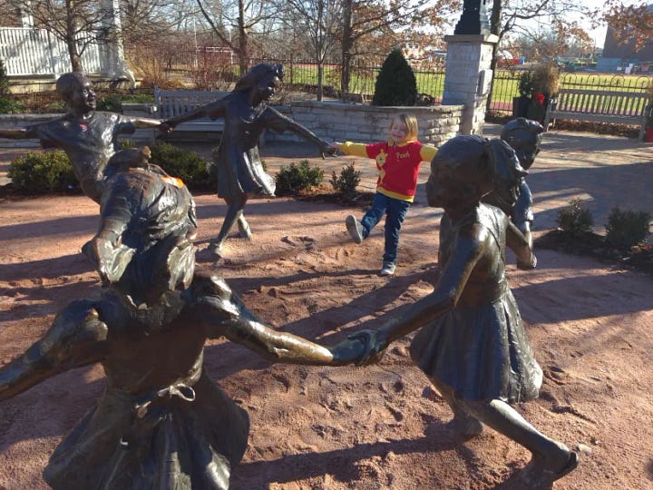 My kiddos climbing up a beanstalk, and my youngest dancing with a statue.