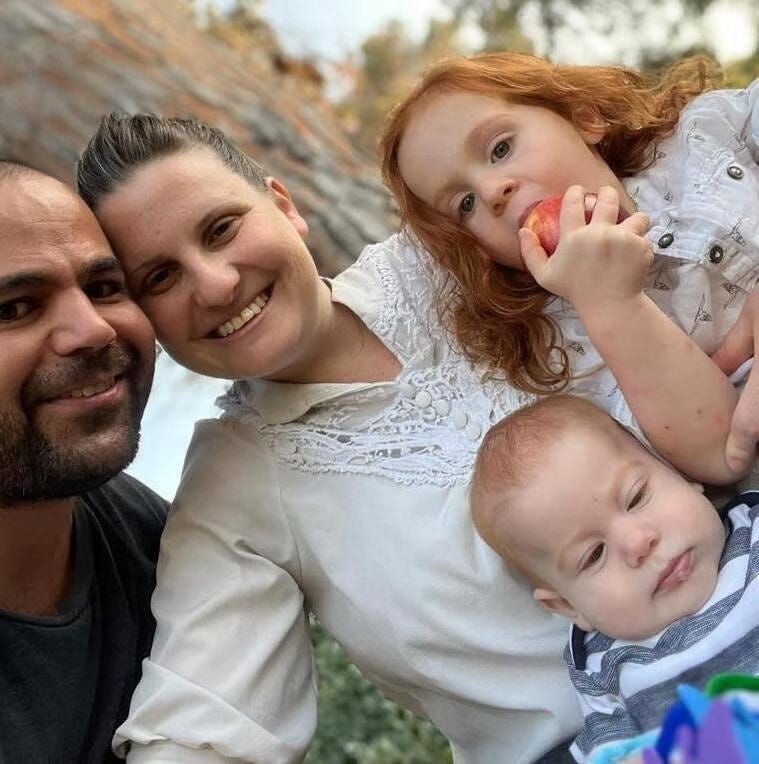 May be an image of 2 people, baby and people smiling