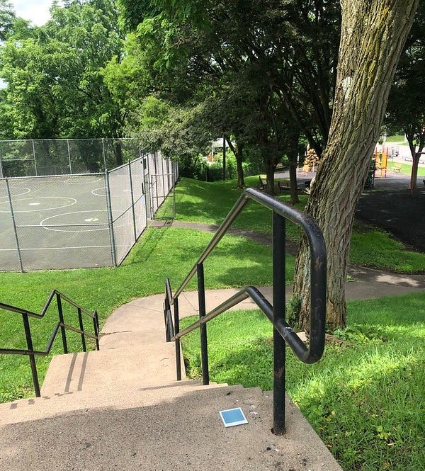 City steps connect to the playground at athletic courts at the park.