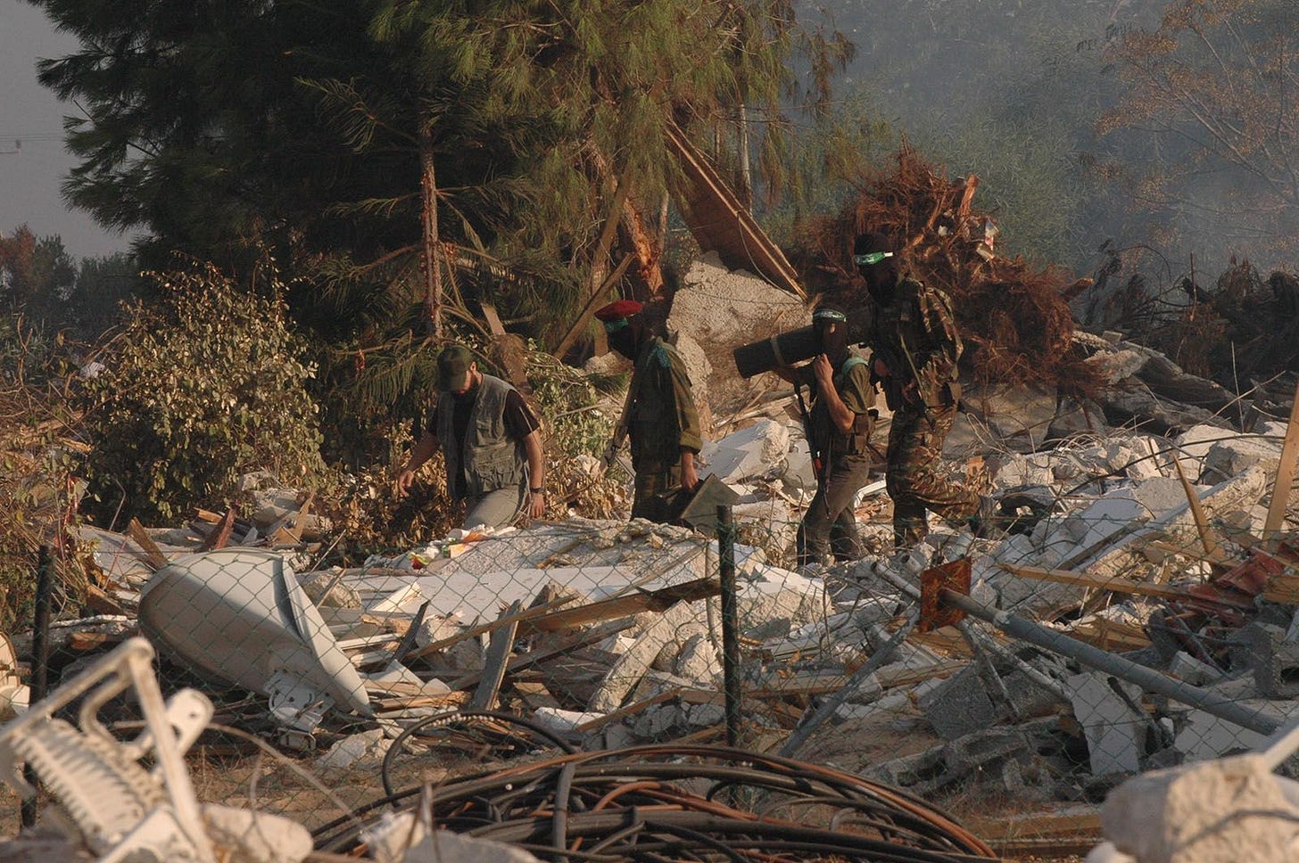 Armed members of the Islamic Jihad Movement walk through the ruins of Neve Dekalim on September 12, 2005. (Photo by Yossi Zamir/Flash90) Armed members of the Islamic Jihad Movement walk through the ruins of Neve Dekalim on September 12, 2005. (Photo by Yossi Zamir/Flash90)