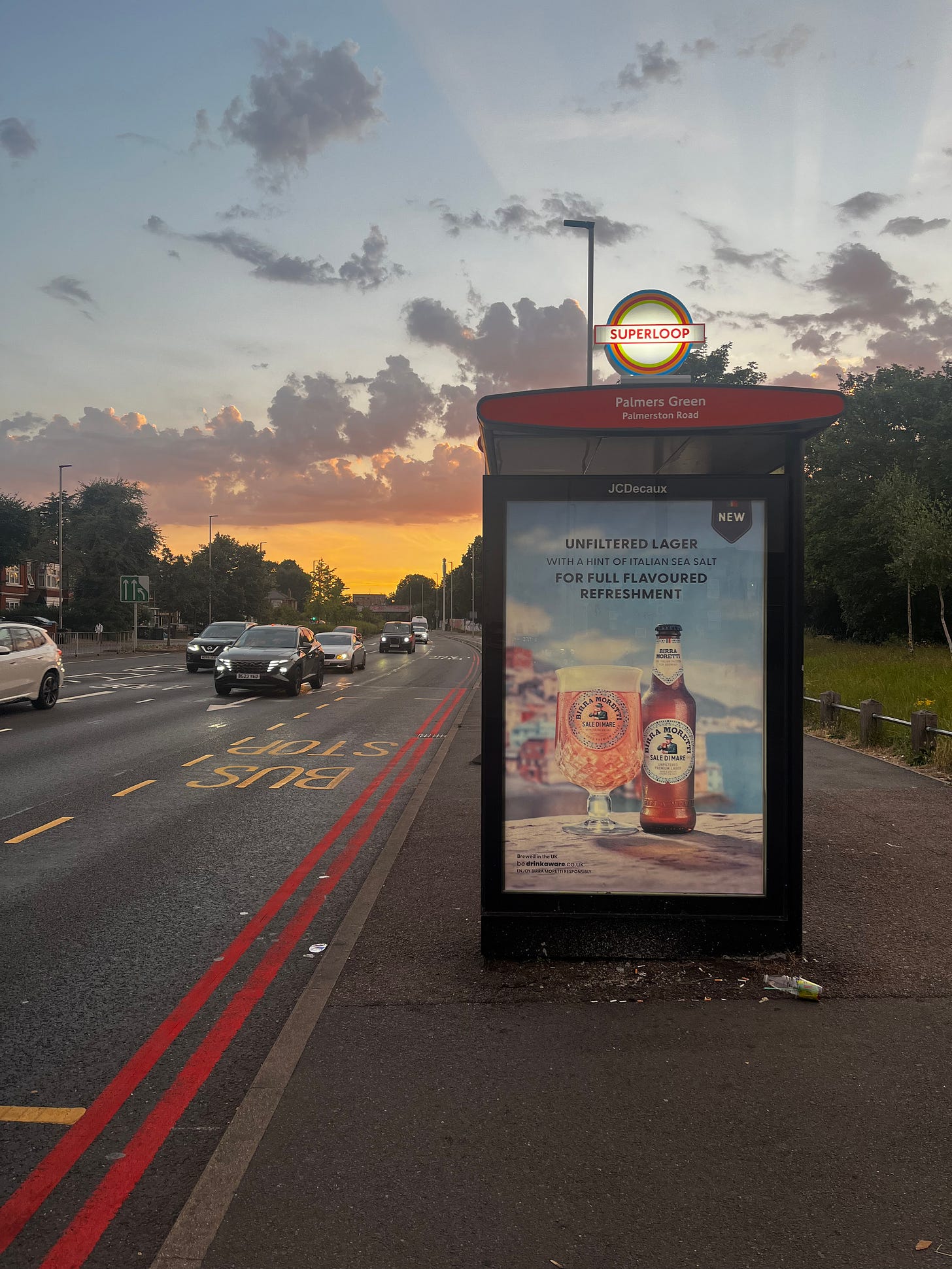 A Superloop branded bus stop at dusk.