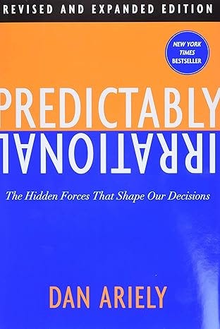 Book cover for Predictably Irrational by Dan Ariely, featuring an orange-and-blue split design with upside-down title text and the subtitle “The Hidden Forces That Shape Our Decisions.”