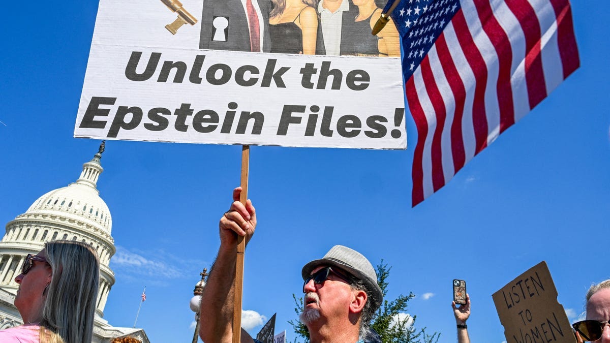 Demonstrators carry signs in support of the victims of sex offender Jeffrey Epstein and his accomplice Ghislaine Maxwell near a press conference held by US representatives outside the U.S. Capitol in Washington, DC on Sept. 3, 2025.