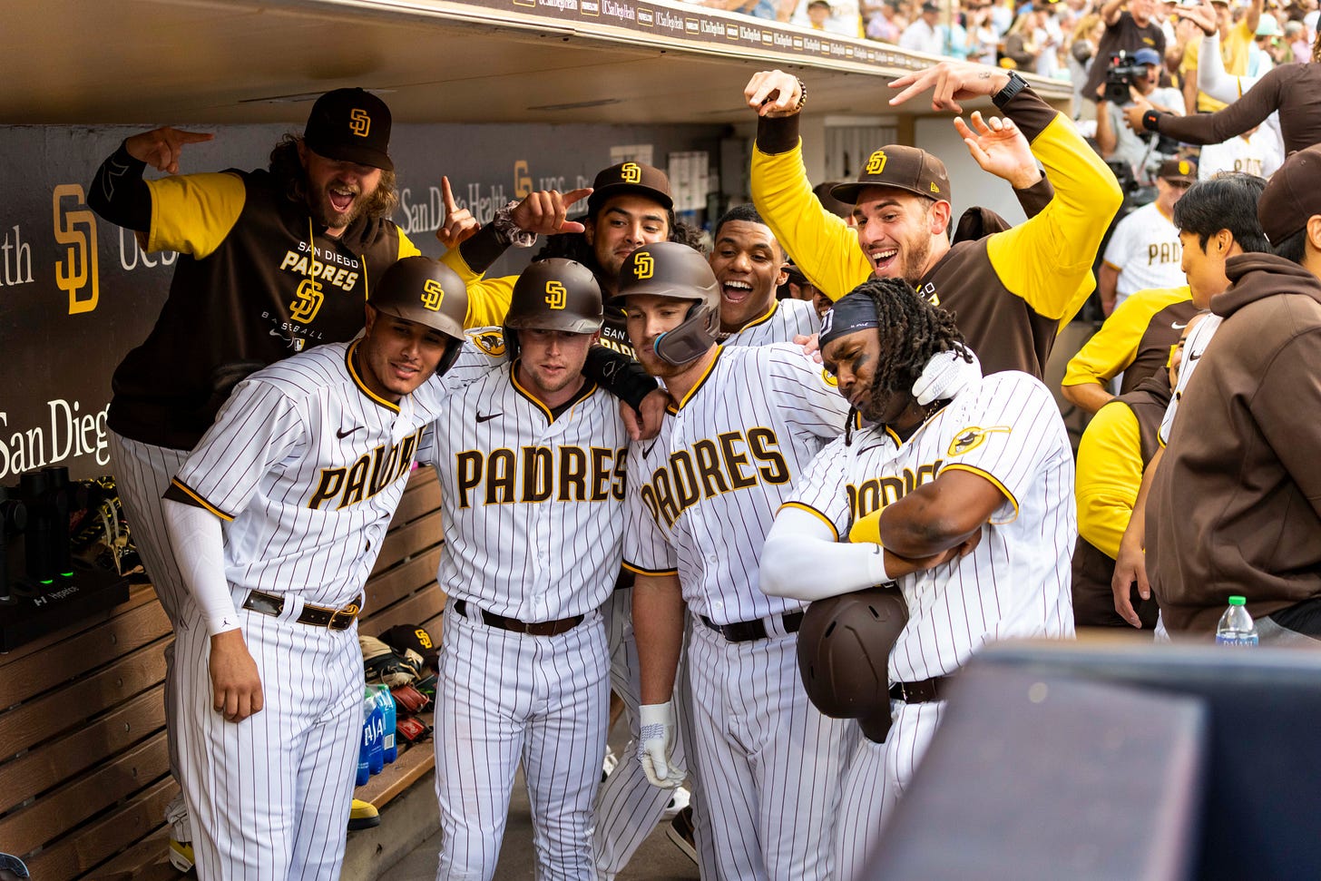 Manny Machado, Jake Cronenworth, Brandon Drury, Josh Bell, Pierce Johnson, Sean Manaea, Juan Soto and Joe Musgrove celebrate and pose for a picture.