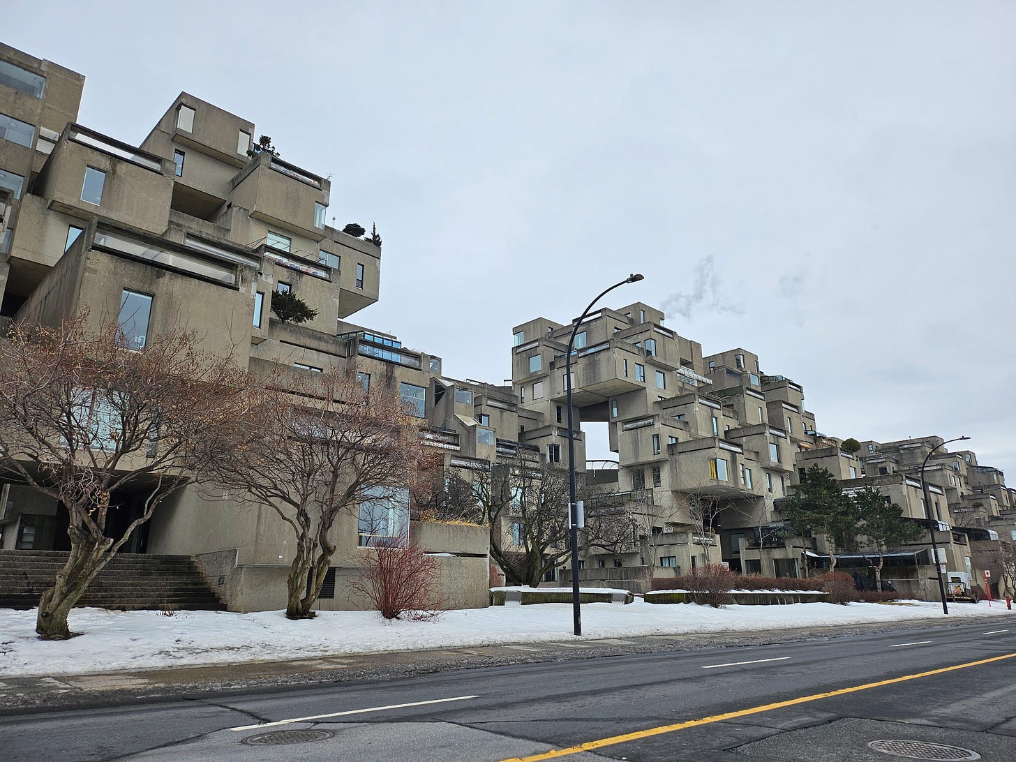 A photo of Habitat 67 in Montreal, a Brutalist-style housing complex with integrated greenery. A photo of Habitat 67 in Montreal, a Brutalist-style housing complex with integrated greenery.
