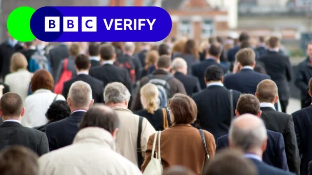 A photo of a crowd of people walking away from the camera