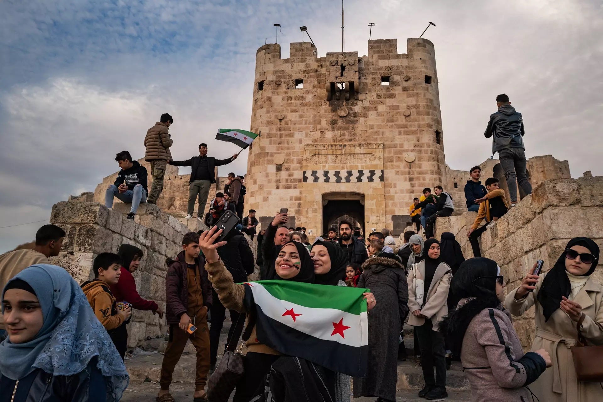 People with opposition flags celebrate the fall of the Assad regime. Aleppo Citadel, 11 December 2024 People with opposition flags celebrate the fall of the Assad regime. Aleppo Citadel, 11 December 2024