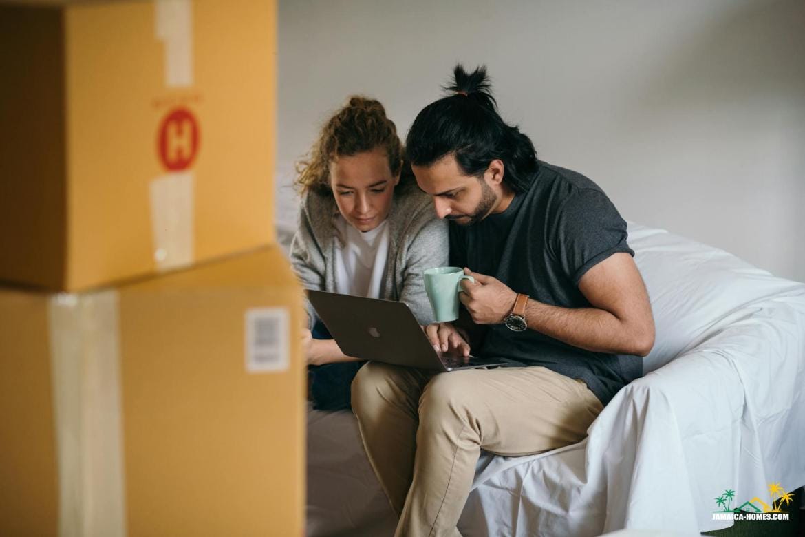 young multiethnic couple watching laptop while moving house