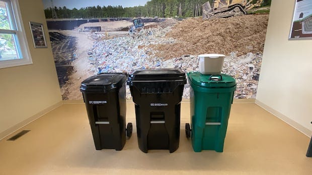 2 black waste bins, a green organics bin, and the small food scraps bin.