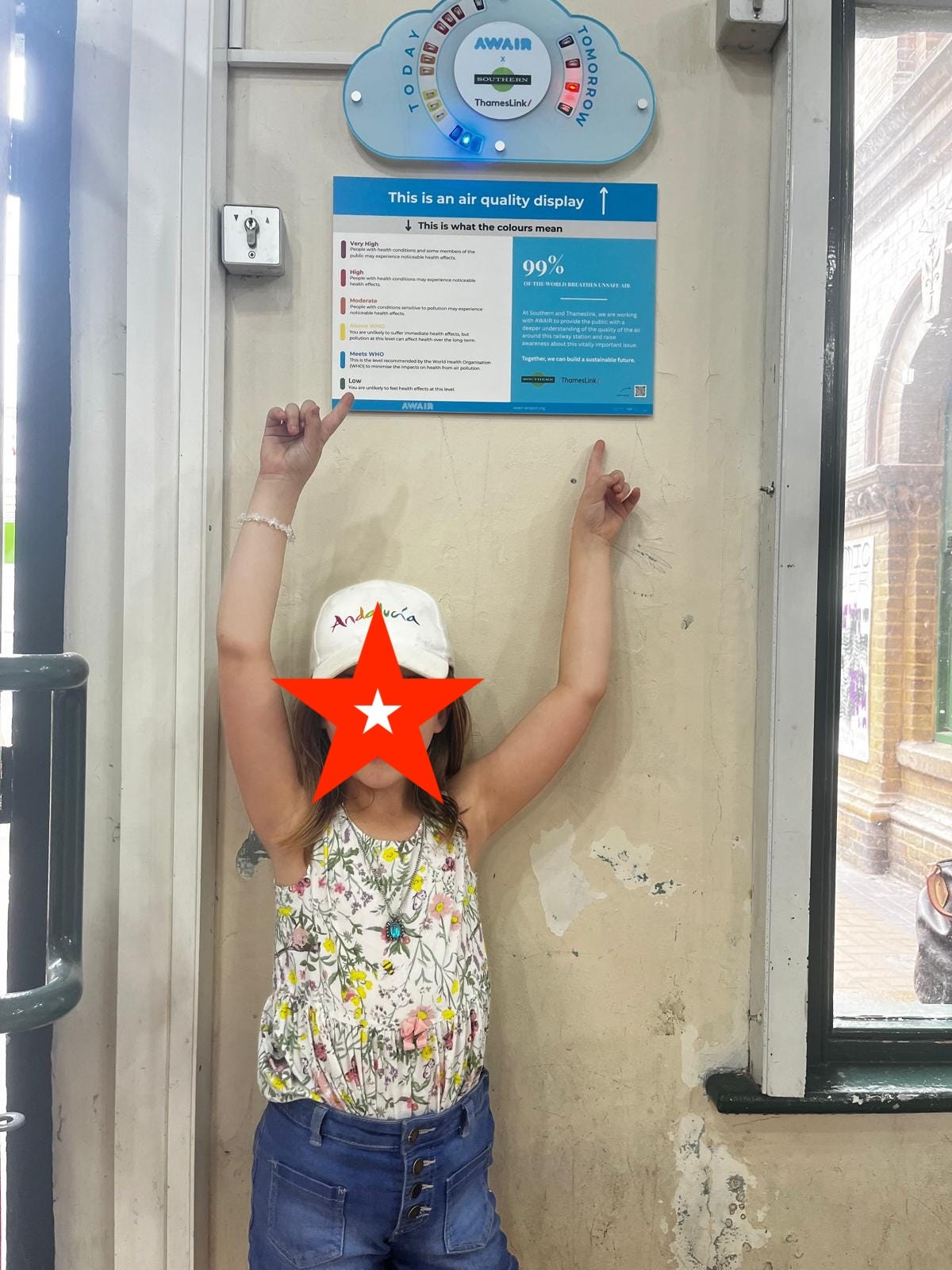Child pointing at an Awair monitor
