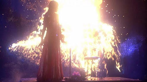 Carrie (1976) - Carrie standing in front of a fire at prom