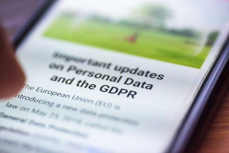 Photo of a person reading about personal data regulation on their smartphone Photo of a person reading about personal data regulation on their smartphone