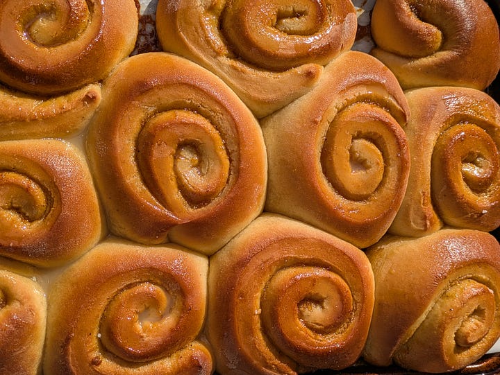 Finished cardamom buns. Gooey cardamom filling on dough.