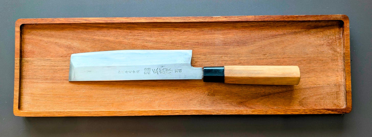 Close-up of a traditional Japanese usuba knife used for precise vegetable cutting.