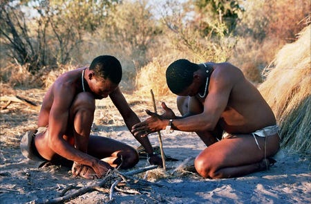 Two San hunter-gatherers starting a fire with the friction created by rubbing a stick. Pictured in Deception Valley, Botswana, in 2005. Credit: Ian Sewell, CC BY-SA 2.5.