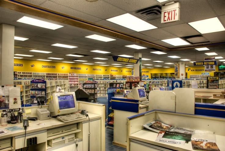 This may contain: the inside of a store with laptops and books