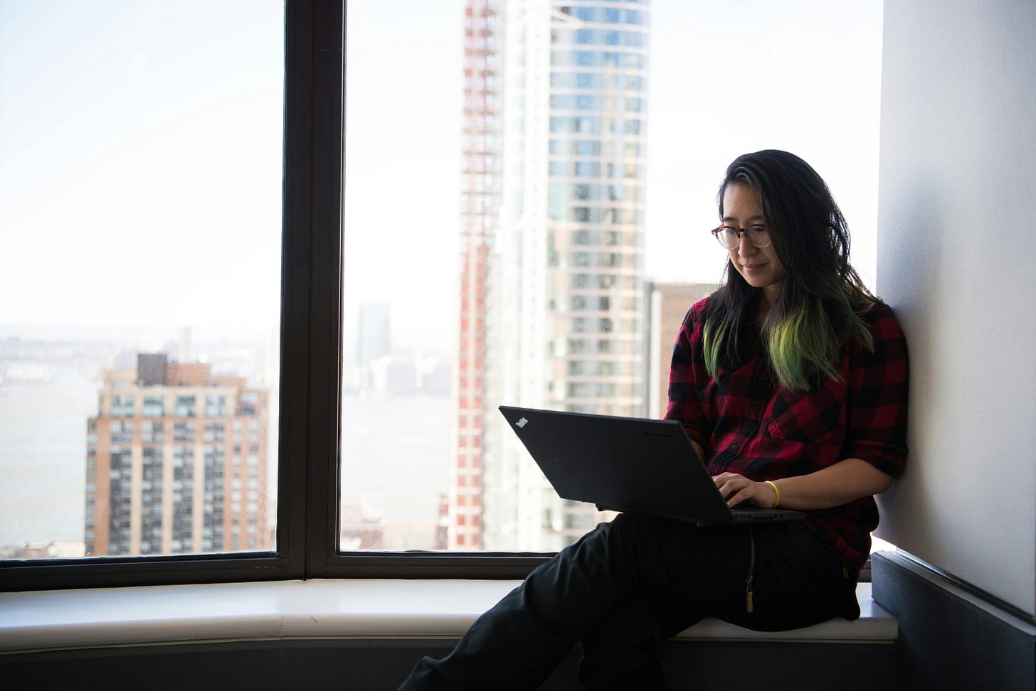 Asian woman using laptop by window, writer, photo for Buhay Copywriter, upskilling