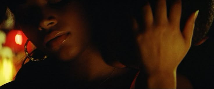 This may contain: a woman holding her hand to her face