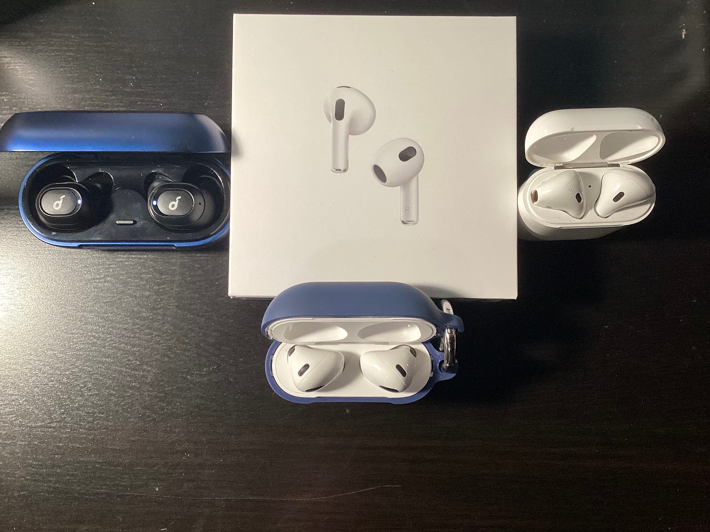 Soundcore Liberty Neos (Left), 3rd Gen AirPods (Middle), and 1st Gen AirPods (Right)