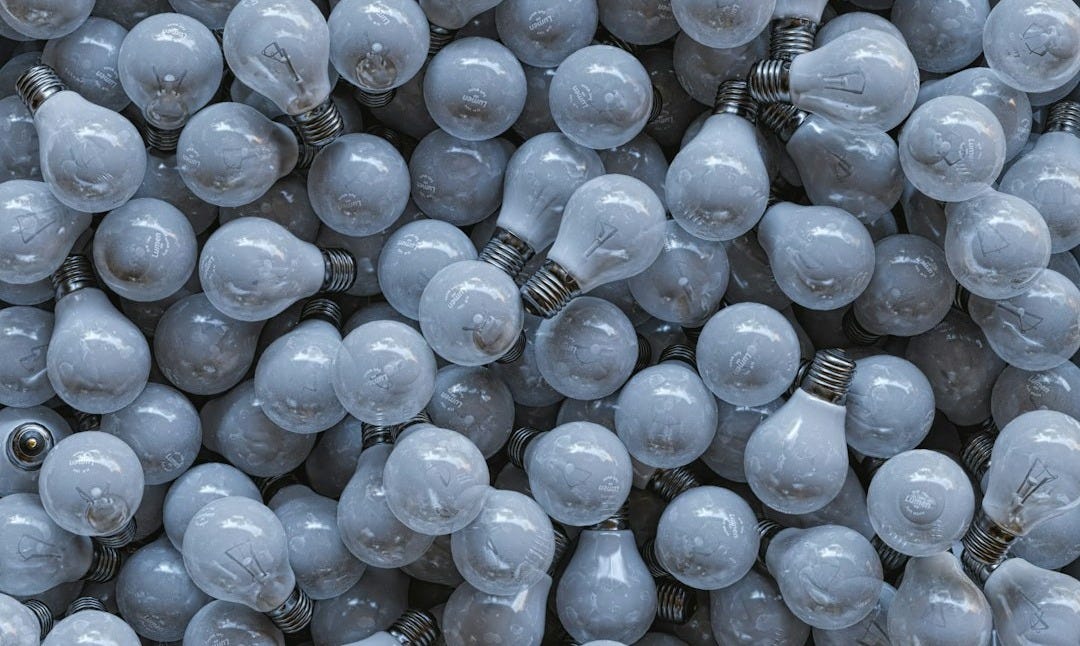 a large pile of light bulbs sitting on top of each other a large pile of light bulbs sitting on top of each other