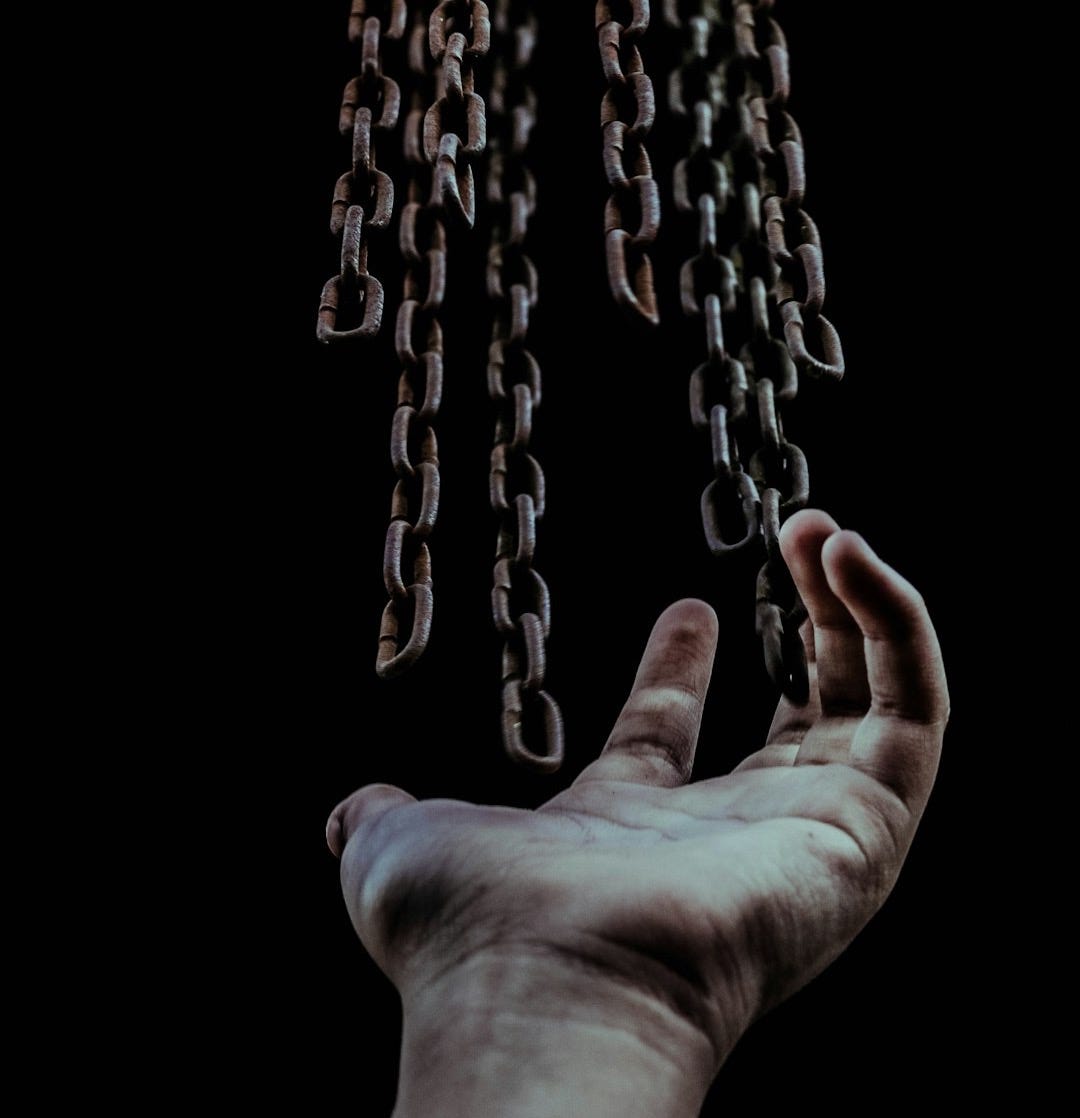 man's hand and chains man's hand and chains