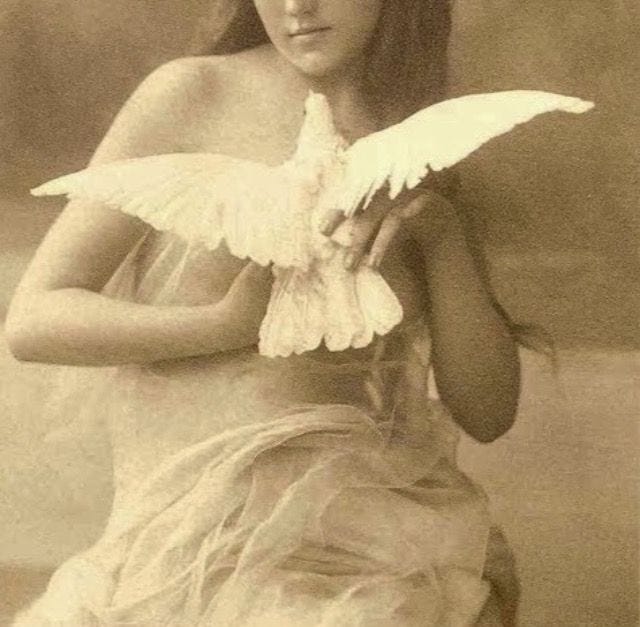 This may contain: an old photo of a young woman holding a bird in her right hand and looking at the camera