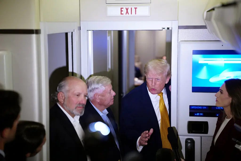 Men in suit jackets standing in the doorway inside an airplane. Men in suit jackets standing in the doorway inside an airplane.