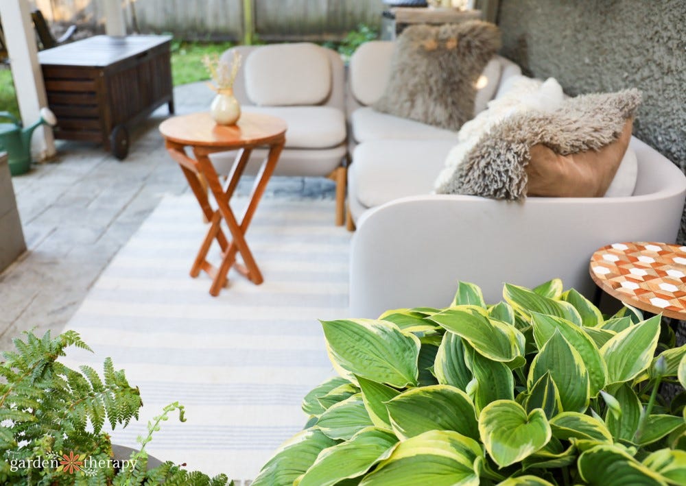 outdoor soft with green potted plants in the foreground outdoor soft with green potted plants in the foreground