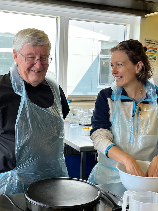 2025-6-26 Becky mixing the dough with John, photo by Nikki Taylor