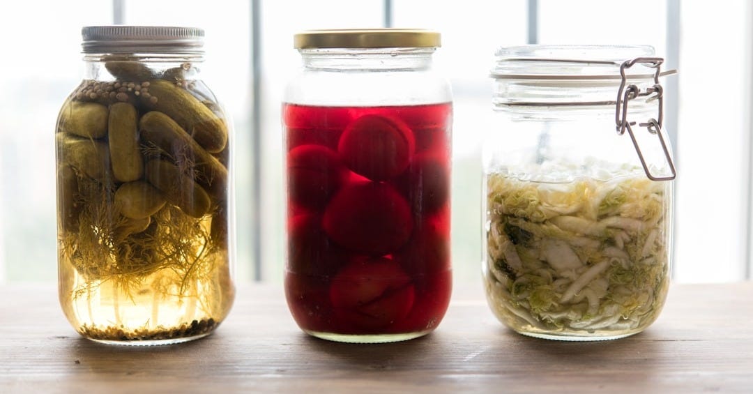 three jars filled with different types of food