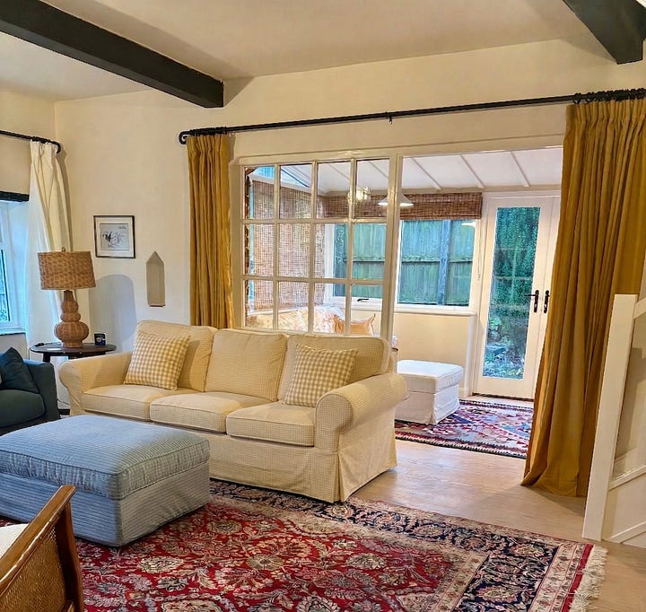 a brass light switch, a living room with a large Persian rug
