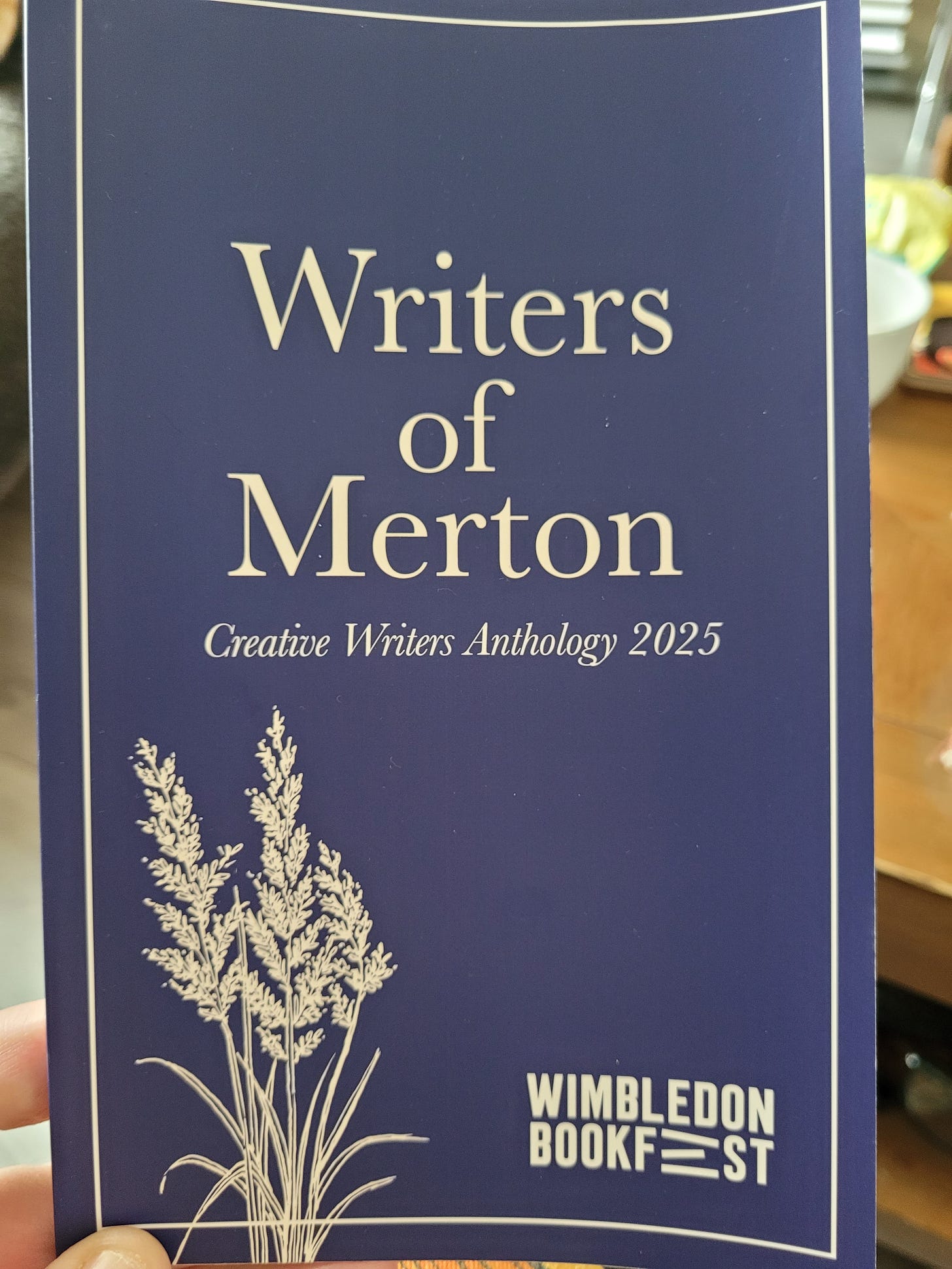 A photo of a book entitled "Writers of Merton Creative Writer Anthology 2025" The cover is dark blue and the writing is gold embossed