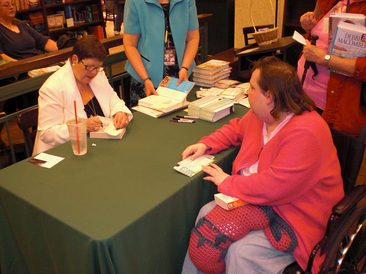 Debi getting a book signed by Debbie Macomber