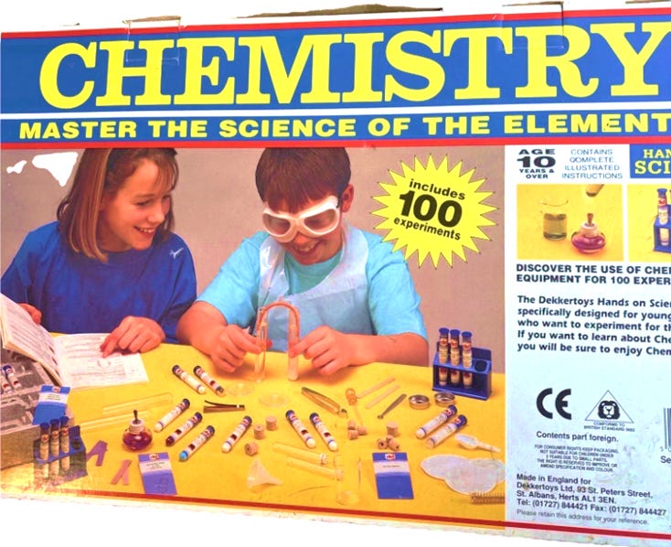 A box of children playing with science equipment